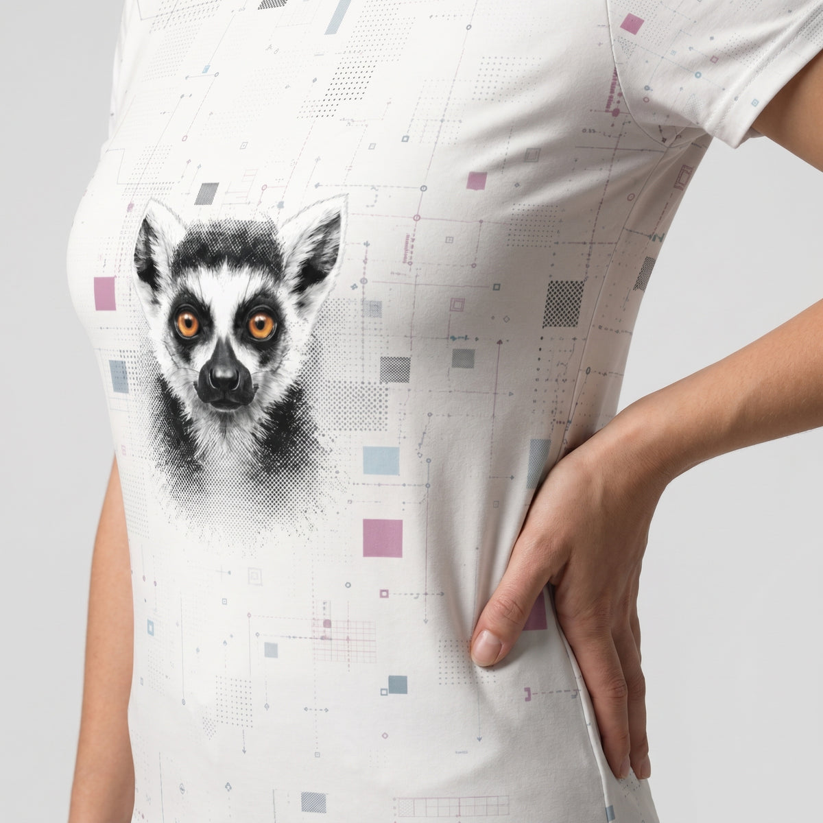 Person wearing a white t-shirt with a lemur graphic on a light gray background