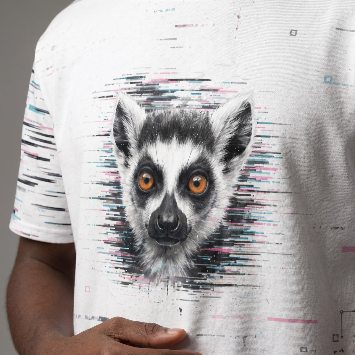 Man wearing a white t-shirt with a lemur graphic on a plain background