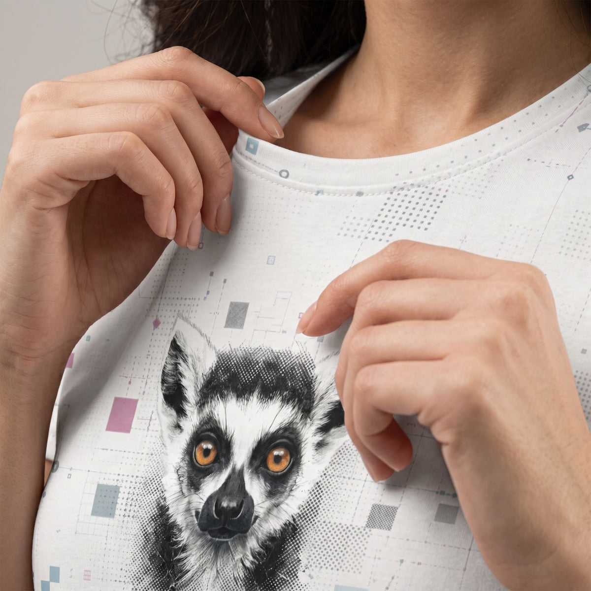 Person wearing a white t-shirt with a lemur design