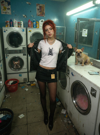 Woman in a laundromat with a dog on a washing machine