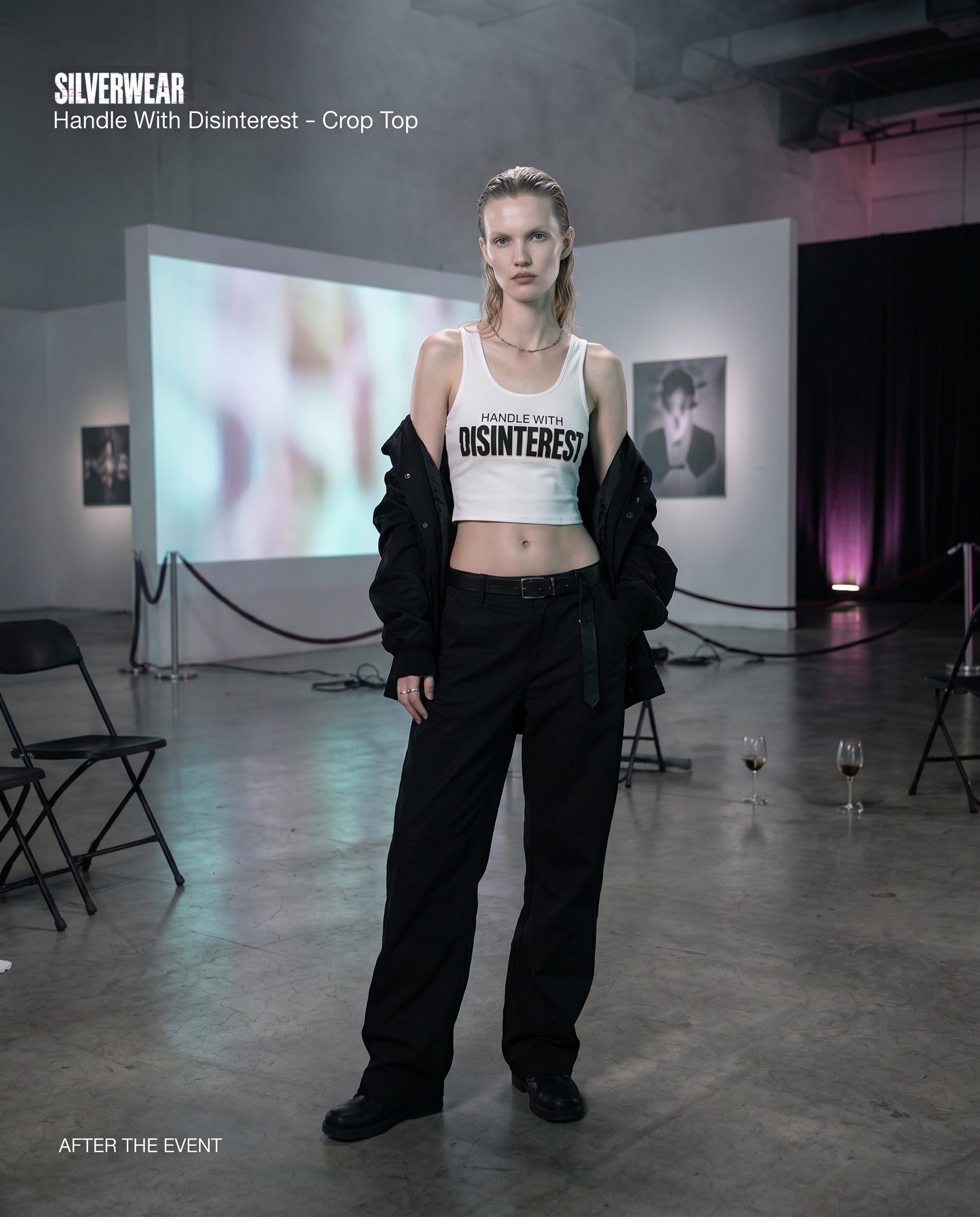 Model wearing a crop top with text in a minimalistic setting