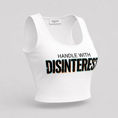 White fitted crop top with bold black HANDLE WITH DISINTEREST print across the chest, angled front view on a plain light background.