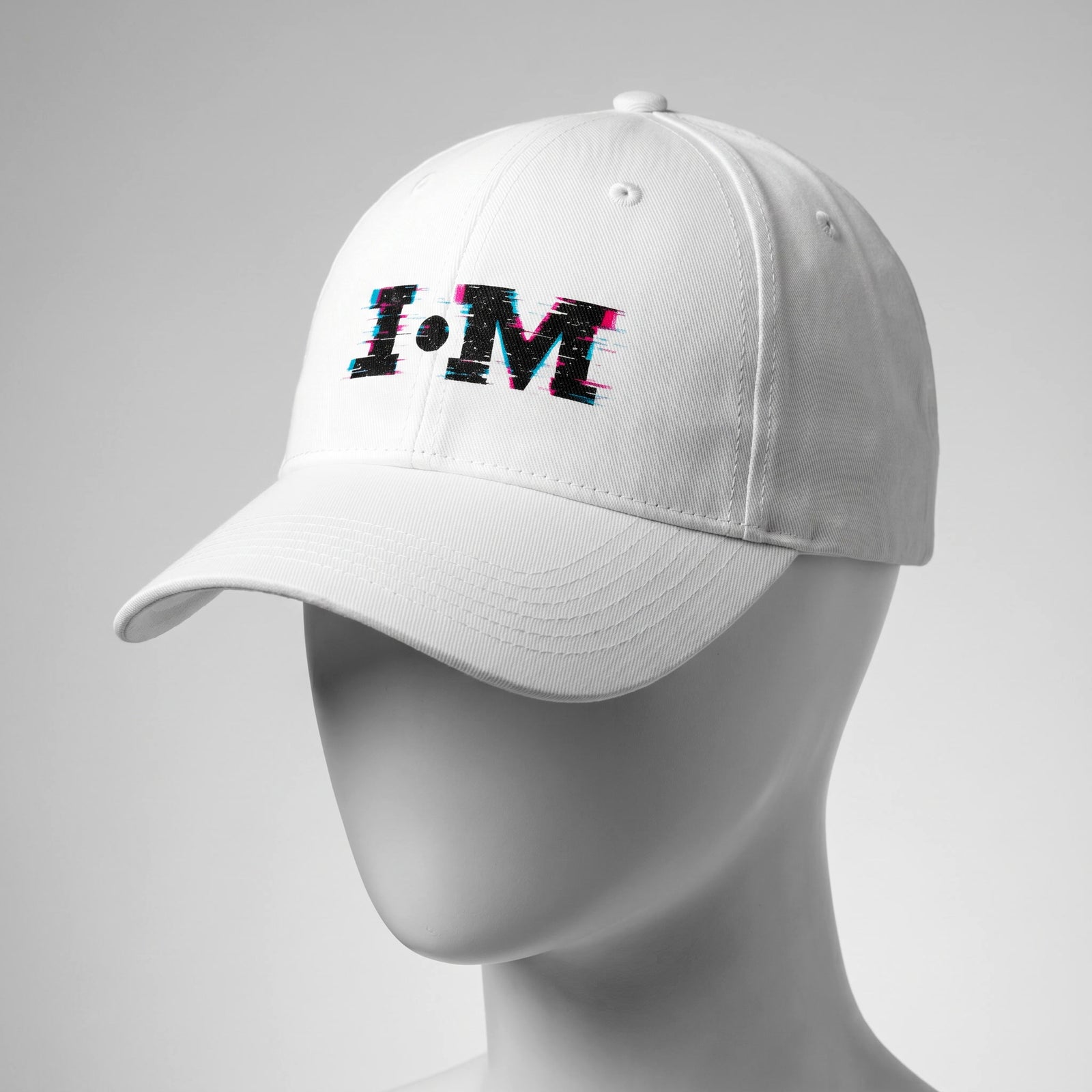 White cap with 'I·M' logo on a gray background