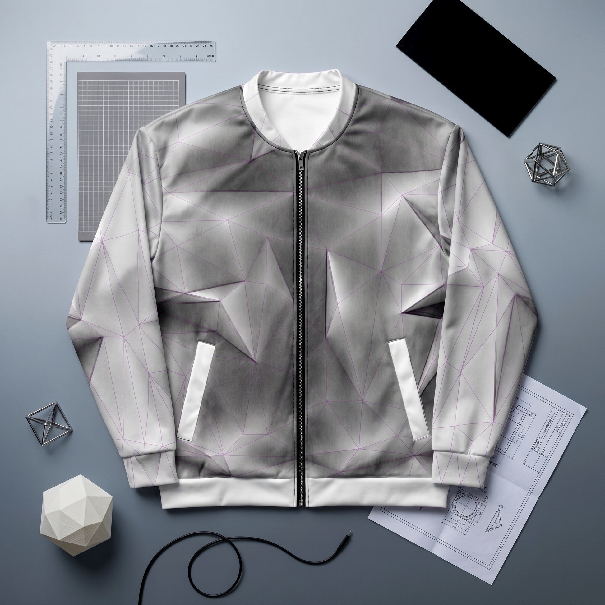 Gray geometric-patterned jacket on a gray background with design tools.