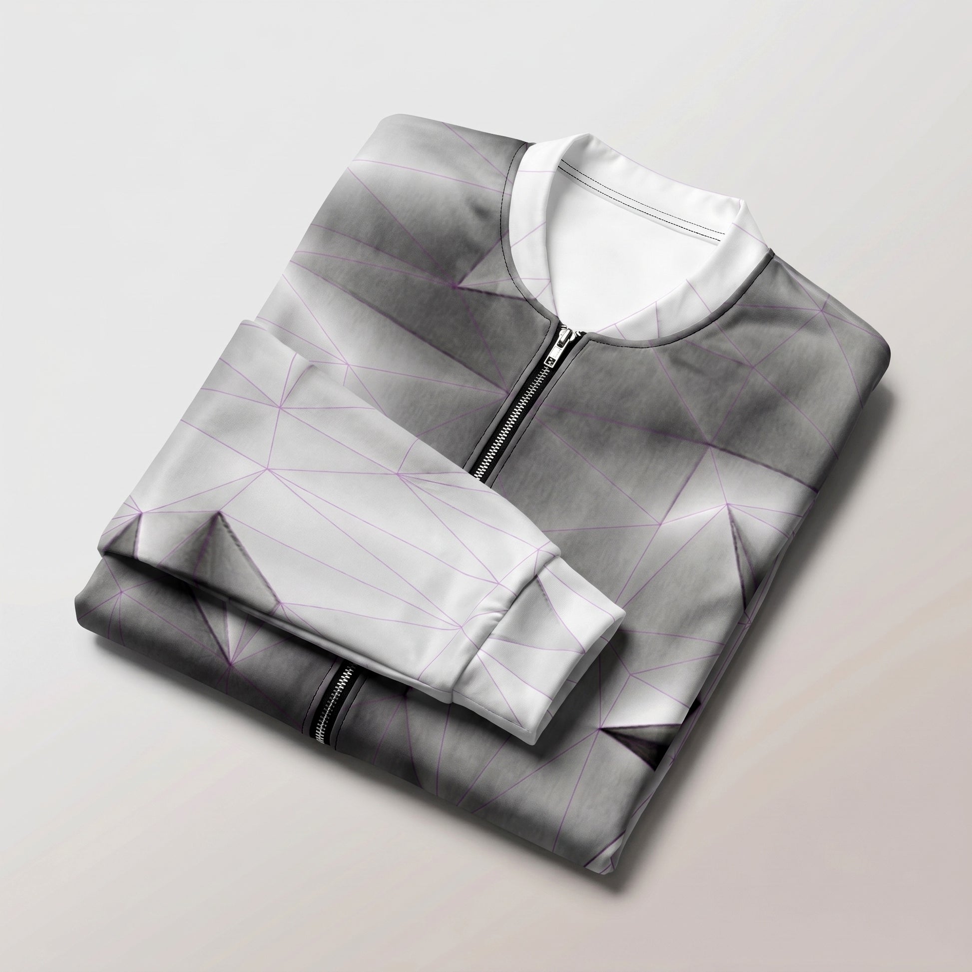 Folded gray and white jacket on a light gray background