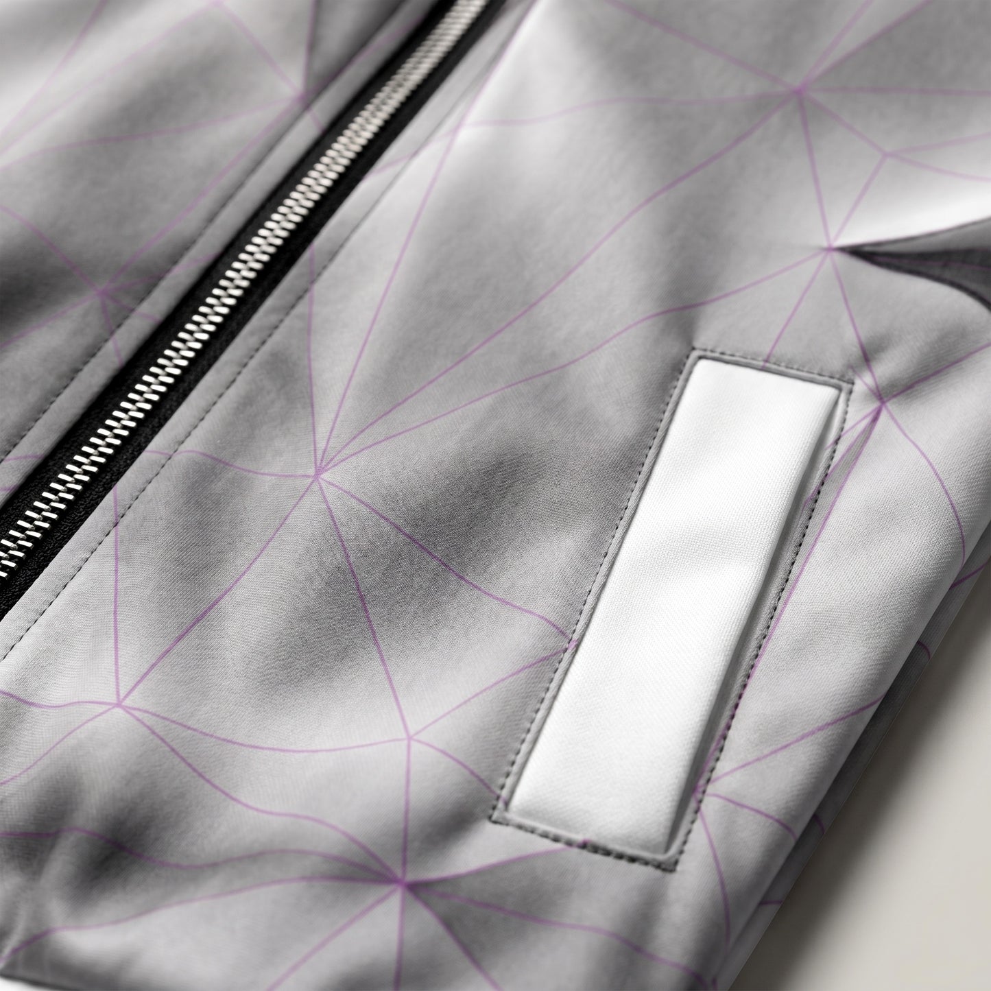Close-up of a gray jacket with geometric pattern and zipper detail