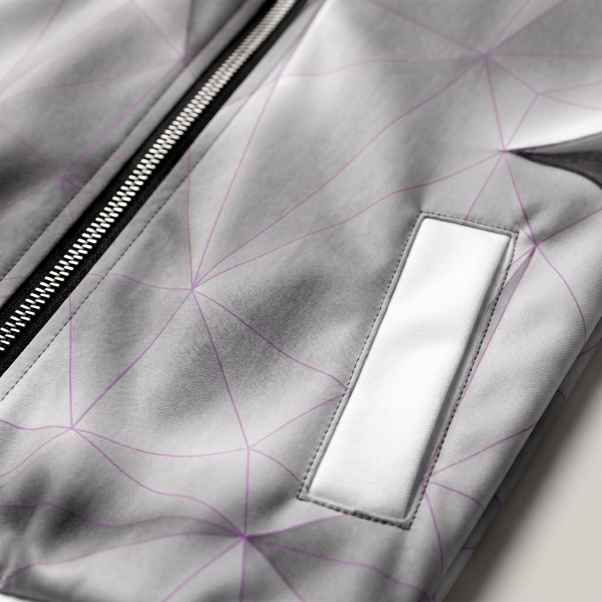Close-up of a gray jacket with geometric pattern and zipper detail