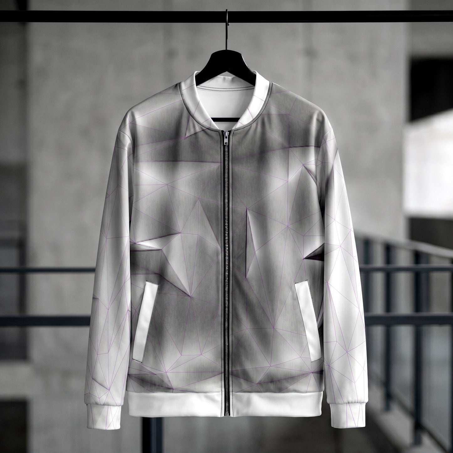 Translucent jacket with geometric patterns on a hanger against a blurred background