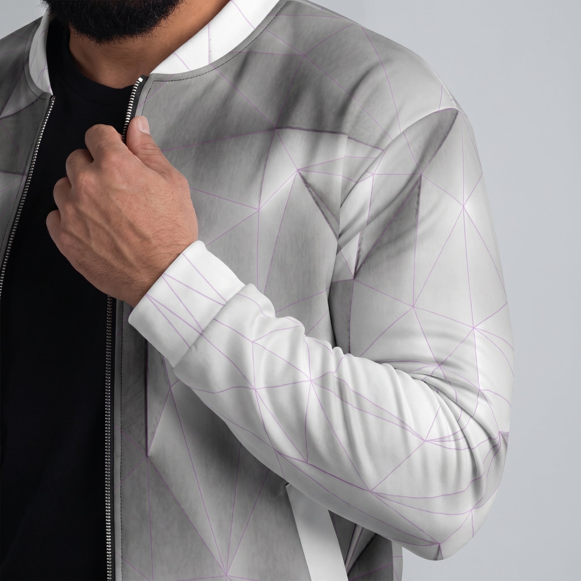 Person wearing a modern, geometric-patterned jacket with a neutral background