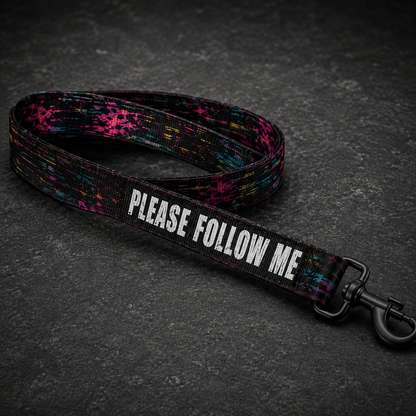 Dog leash with 'PLEASE FOLLOW ME' text on a dark surface