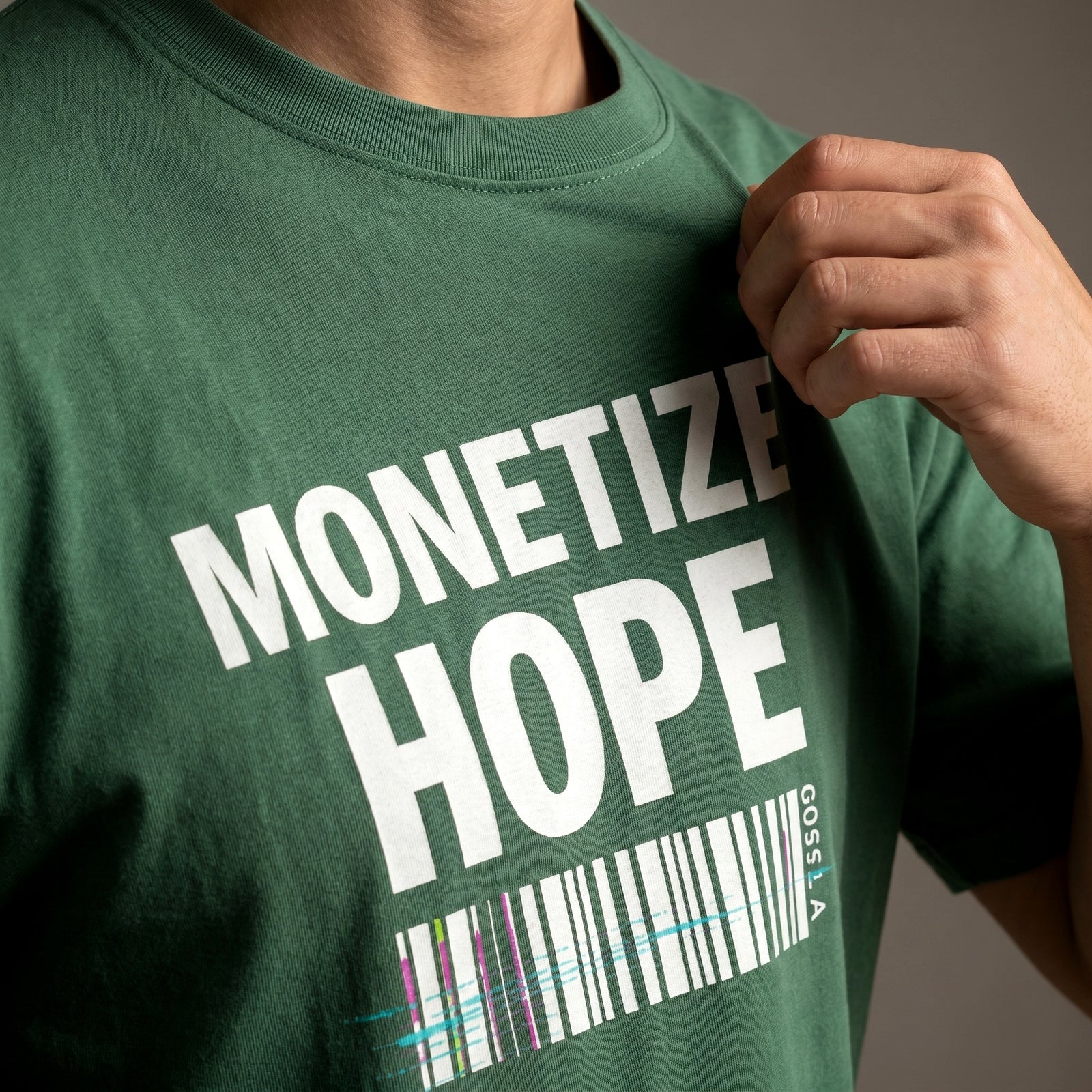 Green t-shirt with 'MONETIZE HOPE' text and barcode design.