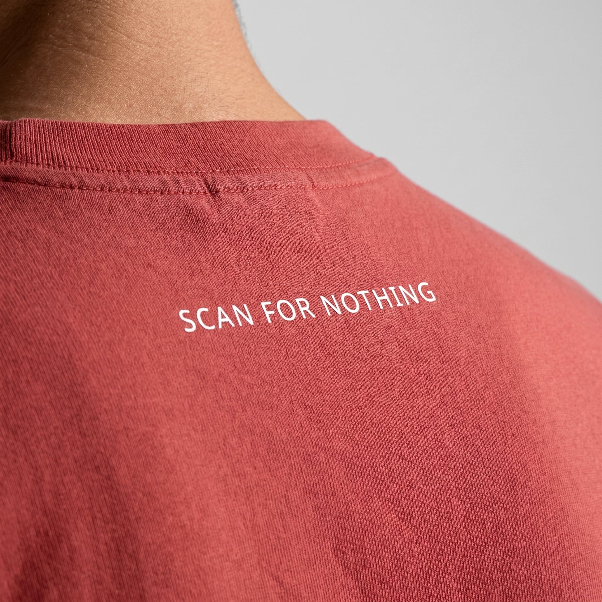 Red t-shirt with 'SCAN FOR NOTHING' text on a plain background