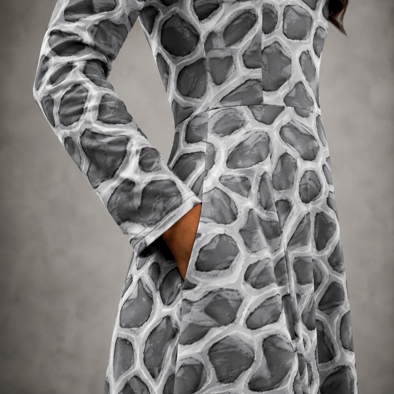 close-up of the ANSO Cellular Mesh Midi Dress side pocket, showing the hand inside the pocket, sleeve cuff, waist seam, fabric texture, and grey cellular mesh pattern.