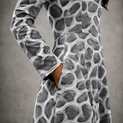close-up of the ANSO Cellular Mesh Midi Dress side pocket, showing the hand inside the pocket, sleeve cuff, waist seam, fabric texture, and grey cellular mesh pattern.