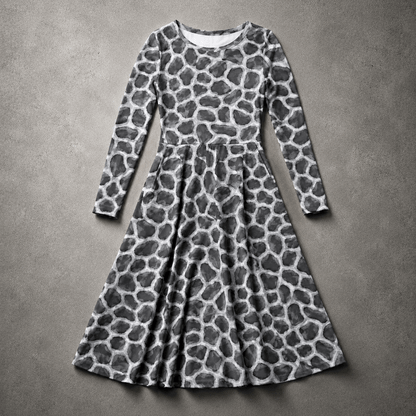 Flat-lay view of the ANSO Cellular Mesh Midi Dress on a textured grey surface, showing the full long-sleeve shape, fitted waist seam, flared skirt, and all-over cellular mesh print.