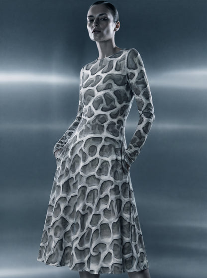Model wearing the ANSO Cellular Mesh Midi Dress in a cinematic blue-grey studio setting with horizontal light bands, highlighting the dress silhouette, pocket detail, and all-over cellular mesh print.