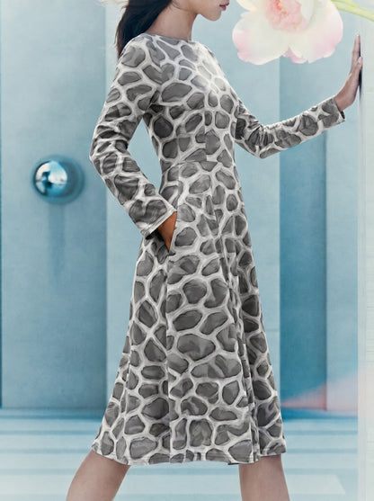 Side-view editorial image of a model wearing the ANSO Cellular Mesh Midi Dress in a soft blue interior, showing the pocket, fitted waist, long sleeves, and flowing midi-length skirt.