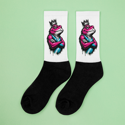Black socks with colorful frog design on a light green background