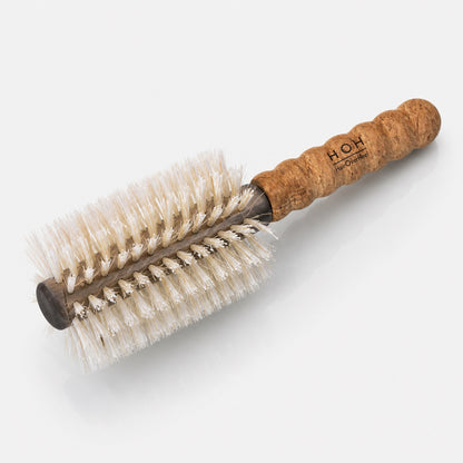 Round hairbrush with cork handle on a white background