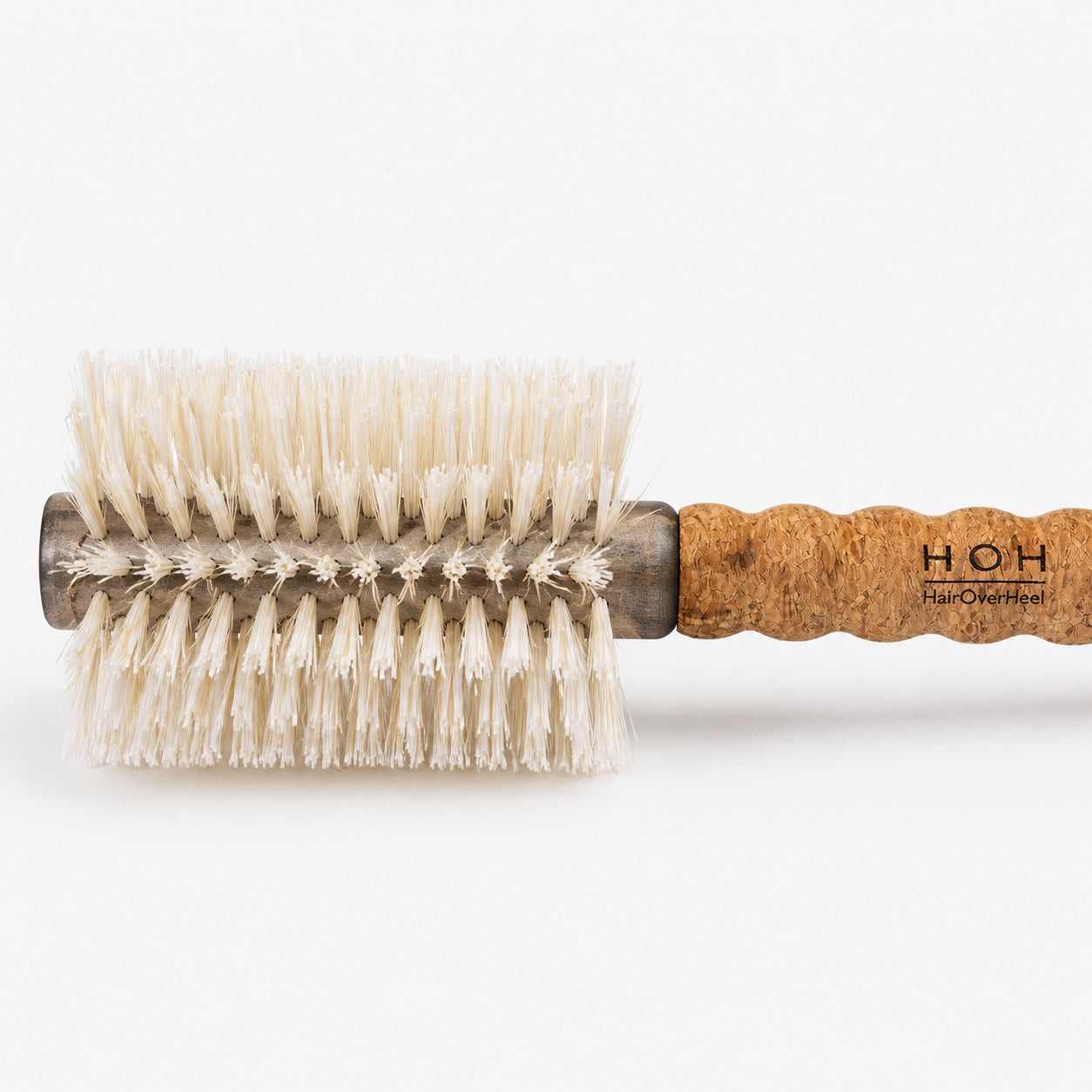 Round hairbrush with cork handle on a white background