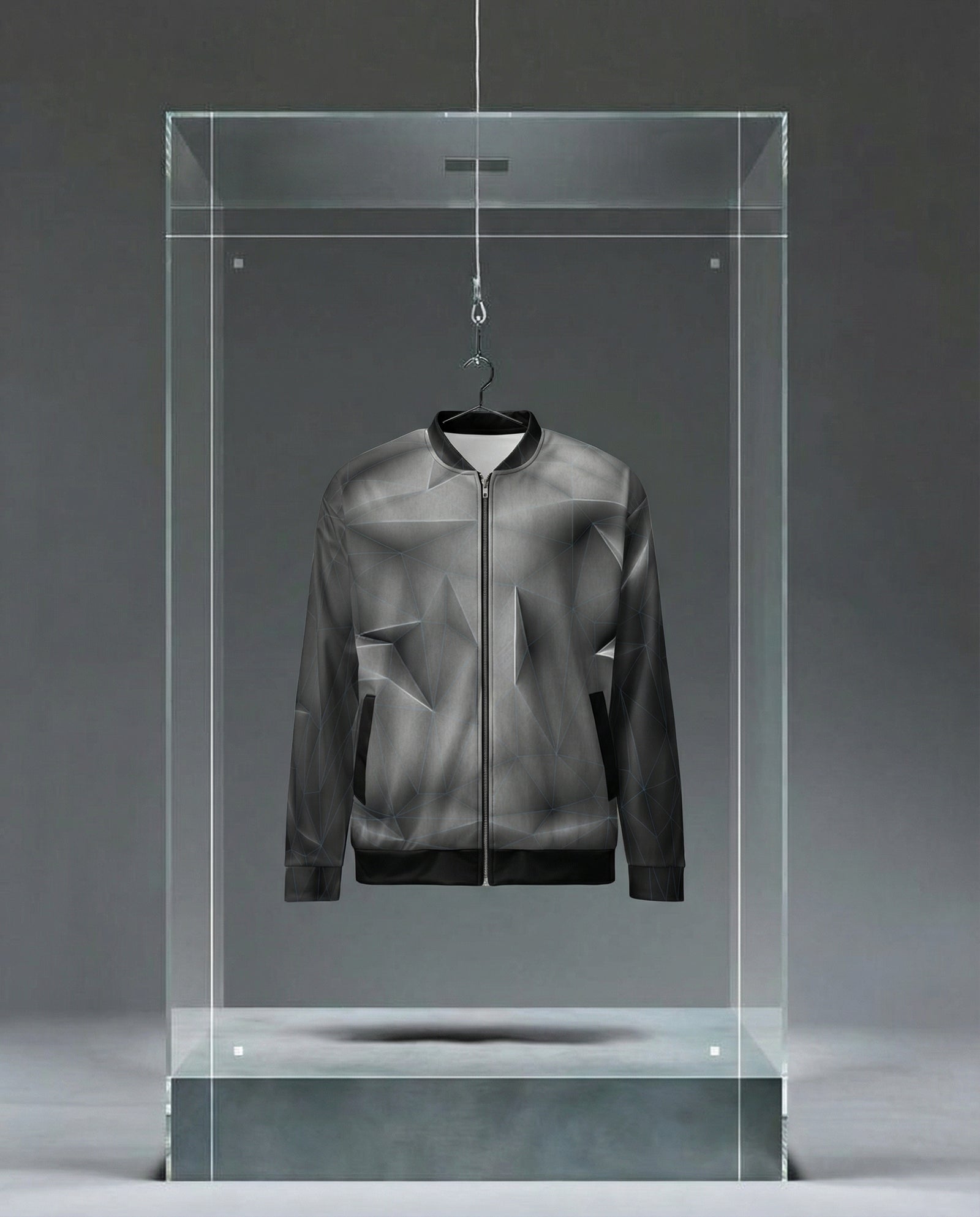 Blue grid 'anso' all-over print bomber jacket displayed in a clear glass case against a gray background
