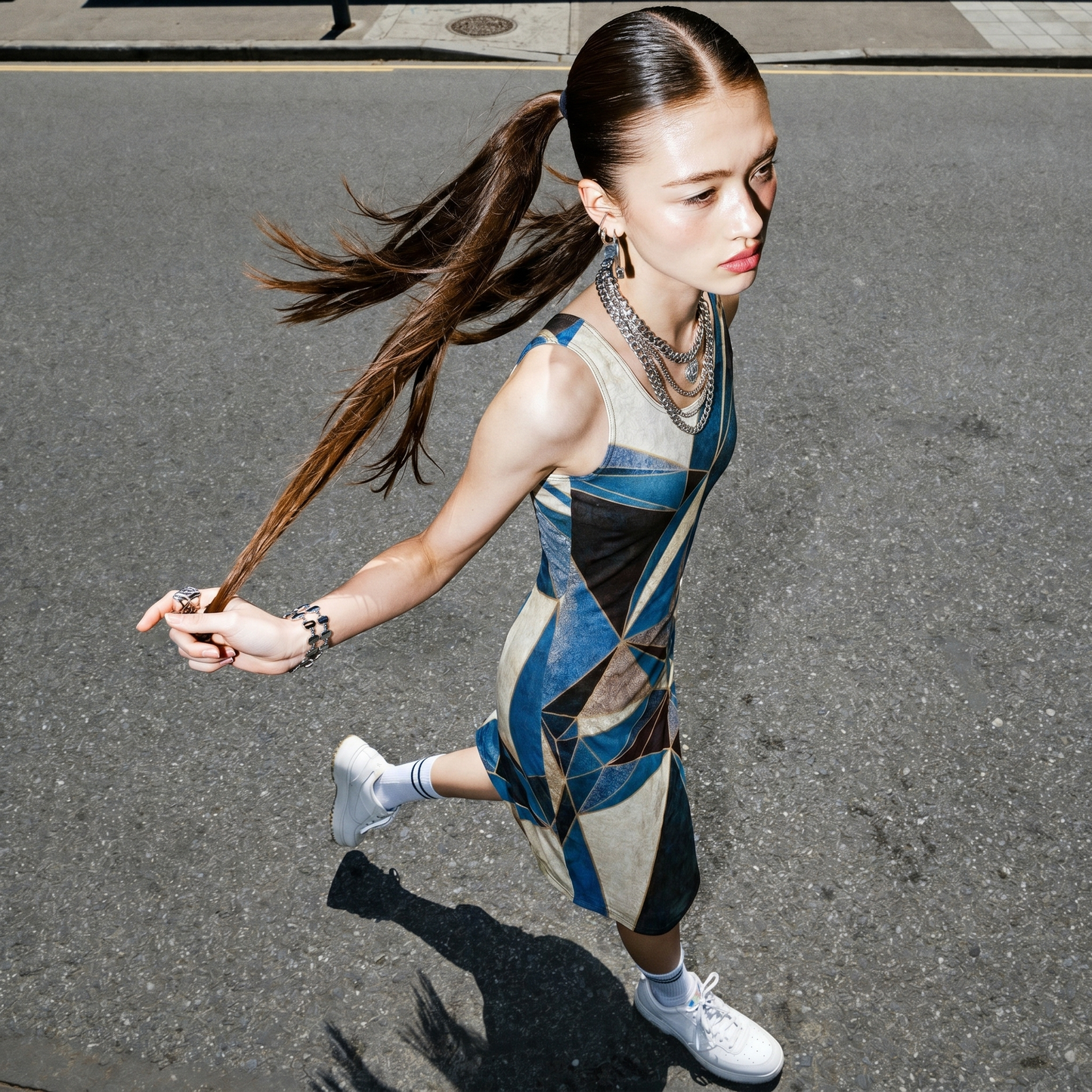 Woman running on a street wearing a geometric patterned dress.