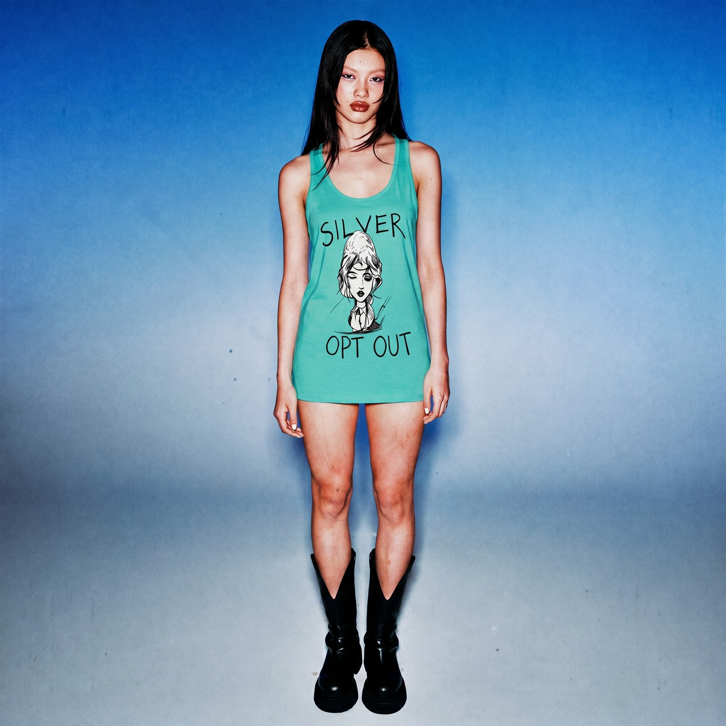 Person wearing a green tank top with text and graphic design on a blue background