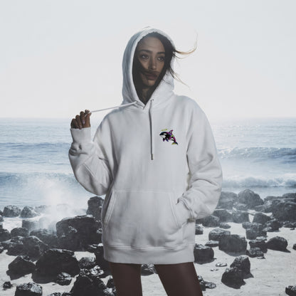 Person wearing a white hoodie with a logo on a rocky beach